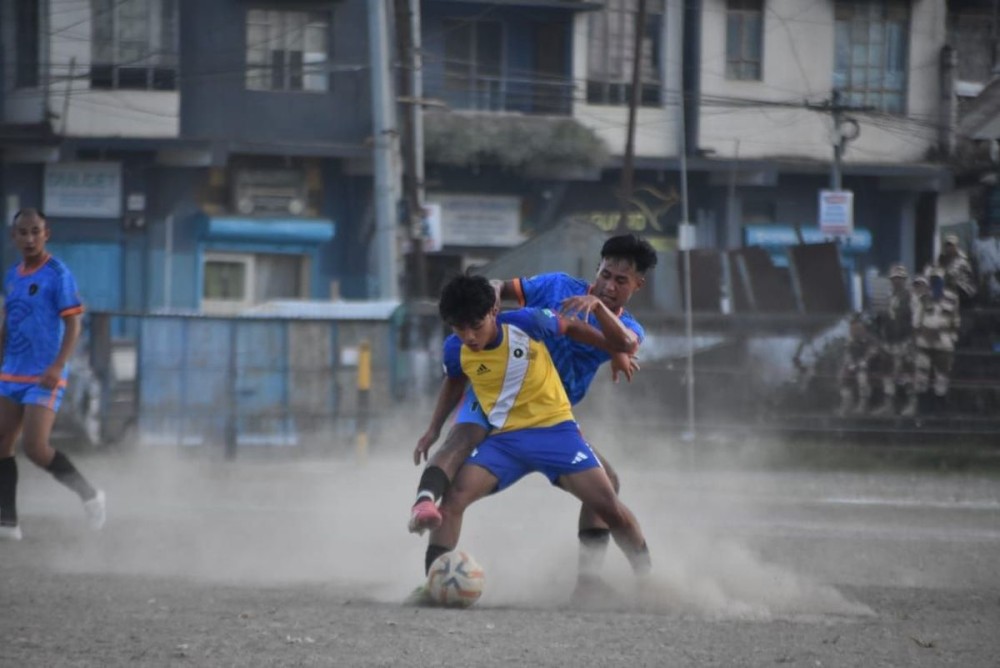 Players of Chargers FC (in blue) and Thunderbolt FC (in yellow and blue) in action during their quarterfinal match of the 27th MDFA Trophy 2025 at Imkongmeren Sports Complex, Mokokchung, on October 21.